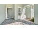 Front entry with gray door and paver walkway at 12420 Destin Loop, Venice, FL 34293
