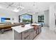Open kitchen with island, copper farm sink, and view into living room at 14219 Wenzel Ave, Port Charlotte, FL 33981