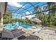Expansive pool and spa with covered lanai and lounge chairs at 14219 Wenzel Ave, Port Charlotte, FL 33981
