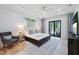 Bright bedroom with king bed, sitting area, and sliding doors to patio at 14219 Wenzel Ave, Port Charlotte, FL 33981