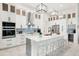 Modern kitchen with white cabinets, large island, and stainless steel appliances at 14219 Wenzel Ave, Port Charlotte, FL 33981