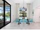 Modern dining room with glass table and blue chairs at 14219 Wenzel Ave, Port Charlotte, FL 33981