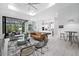 Open living space with a leather couch and access to the pool area at 14219 Wenzel Ave, Port Charlotte, FL 33981