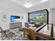 Gathering room with a shuffleboard table and large TV at 14219 Wenzel Ave, Port Charlotte, FL 33981