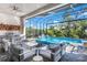 Outdoor kitchen and seating area overlooking the pool at 14219 Wenzel Ave, Port Charlotte, FL 33981