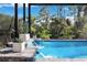 Serene waterfall feature flows into the refreshing pool at 14219 Wenzel Ave, Port Charlotte, FL 33981
