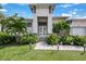 Modern house exterior with lush landscaping and a walkway at 14219 Wenzel Ave, Port Charlotte, FL 33981