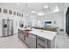 Modern kitchen with a large island, copper sink, and stainless steel appliances at 14219 Wenzel Ave, Port Charlotte, FL 33981