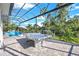 Outdoor oasis with pool, spa, and covered patio; perfect for relaxation and entertaining at 14219 Wenzel Ave, Port Charlotte, FL 33981