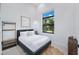 Guest bedroom with a queen-size bed and a large window at 14219 Wenzel Ave, Port Charlotte, FL 33981