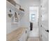 Laundry room with white cabinets, a built-in bench and view to backyard at 14219 Wenzel Ave, Port Charlotte, FL 33981