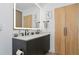 Modern bathroom with double vanity and large mirror at 8175 Dittmar St, Port Charlotte, FL 33981