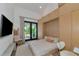 Cozy bedroom with a queen bed, built-in storage, and access to patio at 8175 Dittmar St, Port Charlotte, FL 33981