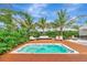 Relaxing pool and spa surrounded by tropical plants at 8175 Dittmar St, Port Charlotte, FL 33981