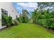 Landscaped backyard with lush tropical plants and grass at 8175 Dittmar St, Port Charlotte, FL 33981