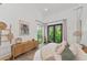 Bright bedroom with king-size bed and access to a private patio at 8175 Dittmar St, Port Charlotte, FL 33981