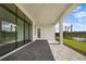 Covered patio with tiled flooring, overlooking a lake at 4612 Mondrian Ct, Sarasota, FL 34240