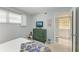 Bedroom with teal dresser, bed, and access to bathroom at 512 W Venice Ave # 403, Venice, FL 34285