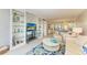 Open concept living area with built-in shelving and a view into dining area at 512 W Venice Ave # 403, Venice, FL 34285