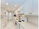 Modern kitchen with white cabinets, updated appliances, and subway tile backsplash at 512 W Venice Ave # 403, Venice, FL 34285