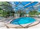 Community pool in a screened enclosure with plenty of lounge chairs at 512 W Venice Ave # 403, Venice, FL 34285