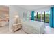 Bright bedroom with comfortable bed, balcony access, and a relaxing view at 512 W Venice Ave # 403, Venice, FL 34285