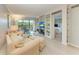 Bright living room with comfy seating, built-in shelving, and wood-look floors at 512 W Venice Ave # 403, Venice, FL 34285