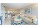 Open living space with light flooring and comfortable furniture, offering views into dining area at 512 W Venice Ave # 403, Venice, FL 34285