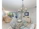 Dining area with glass top table and chandelier at 512 W Venice Ave # 403, Venice, FL 34285