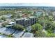 Aerial view of a multi-story building with a pool and surrounding landscape at 512 W Venice Ave # 403, Venice, FL 34285