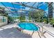 Relaxing community pool with ample seating under a screened enclosure at 512 W Venice Ave # 403, Venice, FL 34285
