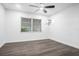 Bright bedroom with ceiling fan and gray vinyl plank flooring at 1522 Pleasant Rd # G23, Bradenton, FL 34207