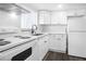 White kitchen with stainless steel appliances and shaker cabinets at 1522 Pleasant Rd # G23, Bradenton, FL 34207