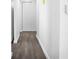 Clean hallway with gray vinyl plank flooring and white walls at 1522 Pleasant Rd # G23, Bradenton, FL 34207