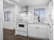 Modern white kitchen with stainless steel appliances and quartz countertops at 1522 Pleasant Rd # G23, Bradenton, FL 34207