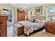 Main bedroom with a king-size bed, wooden furniture, and access to the pool at 5747 29Th E St, Bradenton, FL 34203