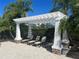 Relaxing pool area with shaded lounge chairs at 6405 Pine Breeze Run, Sarasota, FL 34243