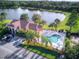 Aerial view of community center, swimming pool, lake, and parking lot at 7818 33Rd E St, Sarasota, FL 34243