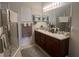 Bright bathroom featuring a double sink vanity, framed mirrors and glass shower at 7818 33Rd E St, Sarasota, FL 34243