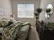 Cozy bedroom featuring bright natural light, complemented by plants and a large mirror enhancing the space at 7818 33Rd E St, Sarasota, FL 34243