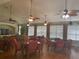 Community center with tables, chairs, ceiling fans, and large windows at 7818 33Rd E St, Sarasota, FL 34243