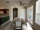 Dining room with a rustic table set for eight, next to sliding doors opening to an outdoor space at 7818 33Rd E St, Sarasota, FL 34243
