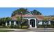 Charming community building with a red tile roof and lush landscaping at 7818 33Rd E St, Sarasota, FL 34243