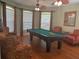Game room with pool table, ceiling fans, hardwood floors, and large windows at 7818 33Rd E St, Sarasota, FL 34243