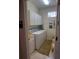 Functional laundry room with a front-loading washer and dryer, plus upper cabinets at 7818 33Rd E St, Sarasota, FL 34243