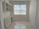 Bright office space with built-in shelving and a large window with blinds at 7818 33Rd E St, Sarasota, FL 34243