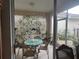 Enclosed patio area with a table and chairs, perfect for outdoor dining at 7818 33Rd E St, Sarasota, FL 34243
