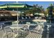 Community pool featuring ample seating, tables, lounge chairs, and umbrellas at 7818 33Rd E St, Sarasota, FL 34243
