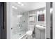 Modern bathroom with marble shower, gray vanity, and stylish decor at 5070 Marsh Field Rd # 2, Sarasota, FL 34235