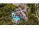 Community pool and clubhouse with surrounding lush greenery at 12528 Palatka Dr, Venice, FL 34293